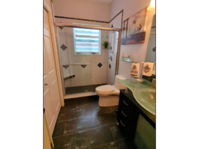 Welcome to this charming 3-bedroom, 2-bathroom WATERFRONT home on East Lake Woodlands Country Club in Florida - for sale on GolfHomes.com, golf home, golf lot