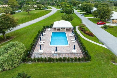 Shimmering lake and golf course views from this luxurious 3 on Quail Ridge Golf Course and Country Club in Florida - for sale on GolfHomes.com, golf home, golf lot