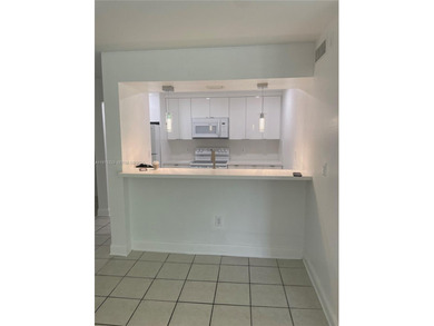 Beautifully updated apartment offering true peace of mind and on Country Club of Miami in Florida - for sale on GolfHomes.com, golf home, golf lot