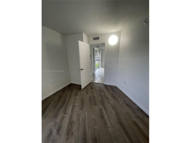 Beautifully updated apartment offering true peace of mind and on Country Club of Miami in Florida - for sale on GolfHomes.com, golf home, golf lot