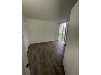 Beautifully updated apartment offering true peace of mind and on Country Club of Miami in Florida - for sale on GolfHomes.com, golf home, golf lot