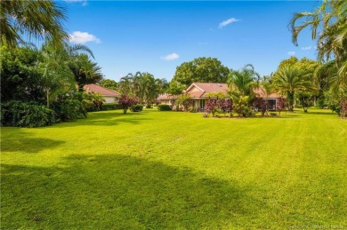 Welcome to this beautifully landscaped 4 bedroom, 2 bath home on St. Lucie Trail Golf Club in Florida - for sale on GolfHomes.com, golf home, golf lot