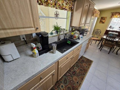 THIS PALM HARBOR 3/2 SPLIT PLAN FEATURES OVER 1300 SQ FT AND HAS on Southport Springs Golf Club in Florida - for sale on GolfHomes.com, golf home, golf lot