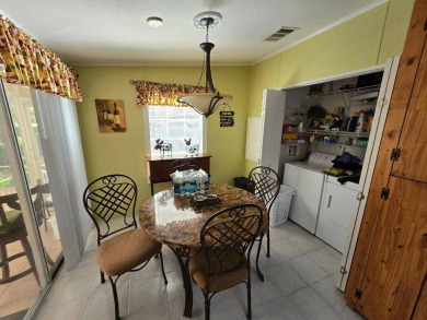 THIS PALM HARBOR 3/2 SPLIT PLAN FEATURES OVER 1300 SQ FT AND HAS on Southport Springs Golf Club in Florida - for sale on GolfHomes.com, golf home, golf lot
