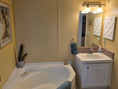 THIS PALM HARBOR 3/2 SPLIT PLAN FEATURES OVER 1300 SQ FT AND HAS on Southport Springs Golf Club in Florida - for sale on GolfHomes.com, golf home, golf lot