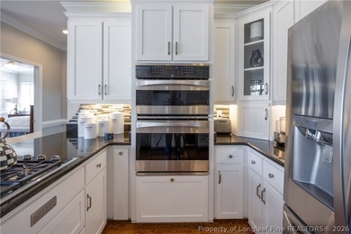 This beautifully updated custom brick home is located on Hole #1 on Sandy Ridge Country Club in North Carolina - for sale on GolfHomes.com, golf home, golf lot