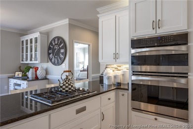 This beautifully updated custom brick home is located on Hole #1 on Sandy Ridge Country Club in North Carolina - for sale on GolfHomes.com, golf home, golf lot