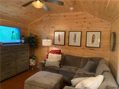 Discover the charm of this cozy tiny log home nestled in the on Cedar Lake Club in New York - for sale on GolfHomes.com, golf home, golf lot