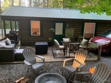 Discover the charm of this cozy tiny log home nestled in the on Cedar Lake Club in New York - for sale on GolfHomes.com, golf home, golf lot