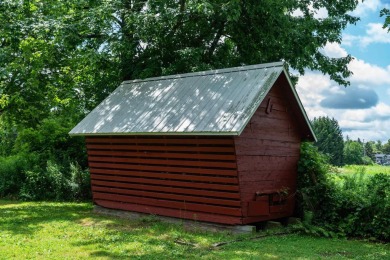 Discover the timeless charm of 9980 Tittabawassee, a historic on Golf Club At Apple Mountain in Michigan - for sale on GolfHomes.com, golf home, golf lot