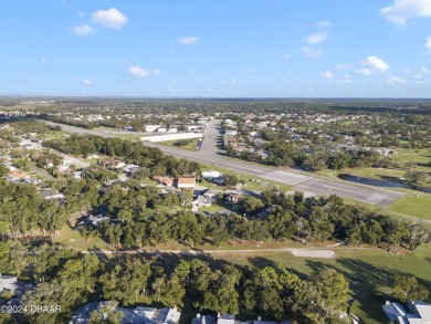 This beautiful brick home, nestled in the prestigious gated on Spruce Creek Golf Club in Florida - for sale on GolfHomes.com, golf home, golf lot