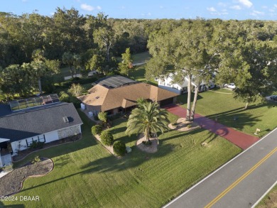 This beautiful brick home, nestled in the prestigious gated on Spruce Creek Golf Club in Florida - for sale on GolfHomes.com, golf home, golf lot