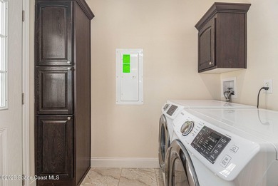 Nestled in the charming community of Barefoot Bay, this stunning on Barefoot Bay Golf Course in Florida - for sale on GolfHomes.com, golf home, golf lot