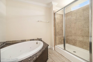 Nestled in the charming community of Barefoot Bay, this stunning on Barefoot Bay Golf Course in Florida - for sale on GolfHomes.com, golf home, golf lot