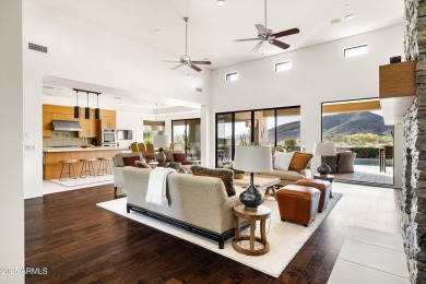 As you enter, you're greeted by soaring ceilings and walls of on Desert Mountain Golf Club - Renegade Course in Arizona - for sale on GolfHomes.com, golf home, golf lot