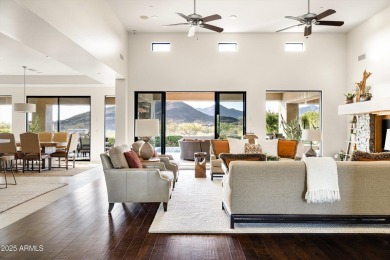As you enter, you're greeted by soaring ceilings and walls of on Desert Mountain Golf Club - Renegade Course in Arizona - for sale on GolfHomes.com, golf home, golf lot
