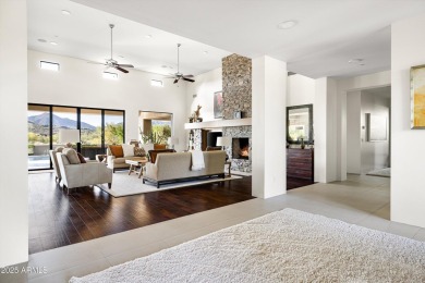 As you enter, you're greeted by soaring ceilings and walls of on Desert Mountain Golf Club - Renegade Course in Arizona - for sale on GolfHomes.com, golf home, golf lot