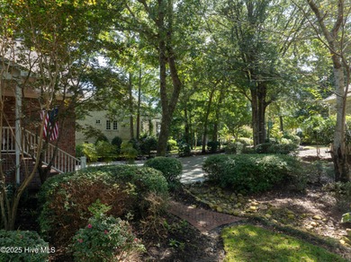Privately nestled among mature trees with serene pond views and on Porters Neck Country Club in North Carolina - for sale on GolfHomes.com, golf home, golf lot