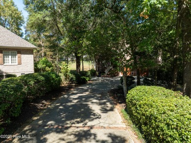 Privately nestled among mature trees with serene pond views and on Porters Neck Country Club in North Carolina - for sale on GolfHomes.com, golf home, golf lot