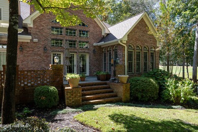 Privately nestled among mature trees with serene pond views and on Porters Neck Country Club in North Carolina - for sale on GolfHomes.com, golf home, golf lot