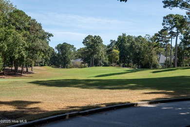 Privately nestled among mature trees with serene pond views and on Porters Neck Country Club in North Carolina - for sale on GolfHomes.com, golf home, golf lot