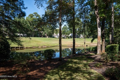 Privately nestled among mature trees with serene pond views and on Porters Neck Country Club in North Carolina - for sale on GolfHomes.com, golf home, golf lot