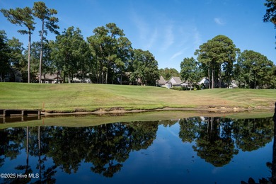 Privately nestled among mature trees with serene pond views and on Porters Neck Country Club in North Carolina - for sale on GolfHomes.com, golf home, golf lot
