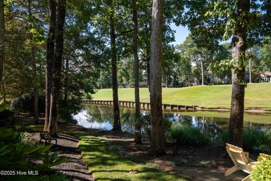 Privately nestled among mature trees with serene pond views and on Porters Neck Country Club in North Carolina - for sale on GolfHomes.com, golf home, golf lot