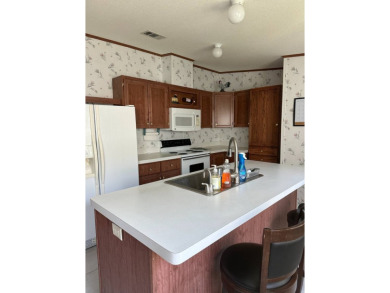 Discover this charming and well-maintained 3-bedroom home on Schalamar Creek Golf and Country Club in Florida - for sale on GolfHomes.com, golf home, golf lot