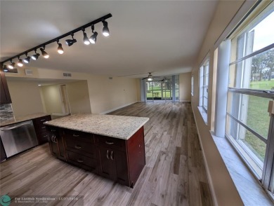 Just Reduced! This beautifully renovated 3-bedroom, 2-bathroom on Woodmont Country Club in Florida - for sale on GolfHomes.com, golf home, golf lot