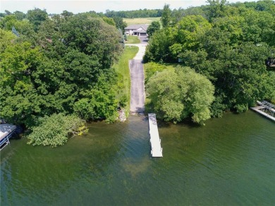 Discover luxurious living in this stunning 5-bedroom, 4-bathroom on Geneva Golf Club in Minnesota - for sale on GolfHomes.com, golf home, golf lot