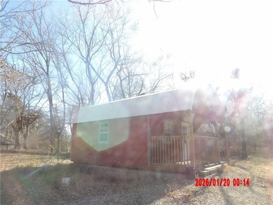 Enjoy this weekend/vacation retreat nestled in the trees on 2 on Sugar Valley Lakes Golf Course in Kansas - for sale on GolfHomes.com, golf home, golf lot