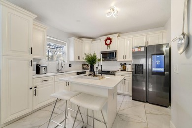 A welcoming blend of style, expertly designed space, and peace on Stoneybrook East Golf Club in Florida - for sale on GolfHomes.com, golf home, golf lot