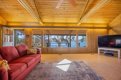 Discover this beautifully preserved mid-century lake house on Francis Lake Golf Club in Georgia - for sale on GolfHomes.com, golf home, golf lot