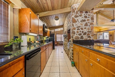 Discover this beautifully preserved mid-century lake house on Francis Lake Golf Club in Georgia - for sale on GolfHomes.com, golf home, golf lot