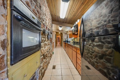 Discover this beautifully preserved mid-century lake house on Francis Lake Golf Club in Georgia - for sale on GolfHomes.com, golf home, golf lot