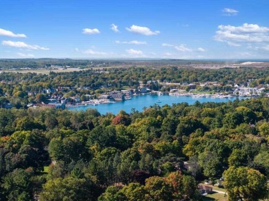 Built on a spacious scenic lot on the north side of Downtown on Charlevoix Golf Club in Michigan - for sale on GolfHomes.com, golf home, golf lot