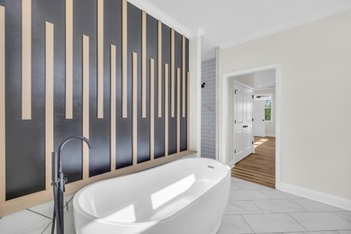 Discover the epitome of lakeside living at 301 Portland Circle on The Links At Stoney Point in South Carolina - for sale on GolfHomes.com, golf home, golf lot