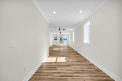 Discover the epitome of lakeside living at 301 Portland Circle on The Links At Stoney Point in South Carolina - for sale on GolfHomes.com, golf home, golf lot