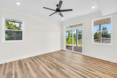 Discover the epitome of lakeside living at 301 Portland Circle on The Links At Stoney Point in South Carolina - for sale on GolfHomes.com, golf home, golf lot