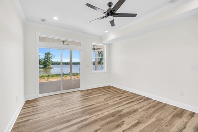 Discover the epitome of lakeside living at 301 Portland Circle on The Links At Stoney Point in South Carolina - for sale on GolfHomes.com, golf home, golf lot