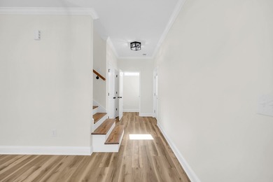 Discover the epitome of lakeside living at 301 Portland Circle on The Links At Stoney Point in South Carolina - for sale on GolfHomes.com, golf home, golf lot