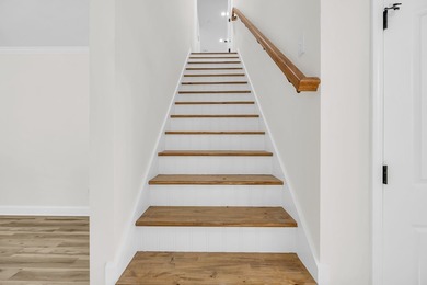 Discover the epitome of lakeside living at 301 Portland Circle on The Links At Stoney Point in South Carolina - for sale on GolfHomes.com, golf home, golf lot