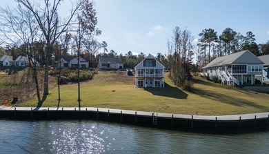 Discover the epitome of lakeside living at 301 Portland Circle on The Links At Stoney Point in South Carolina - for sale on GolfHomes.com, golf home, golf lot