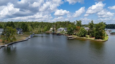 Discover the epitome of lakeside living at 301 Portland Circle on The Links At Stoney Point in South Carolina - for sale on GolfHomes.com, golf home, golf lot