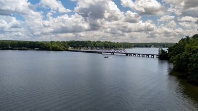 Discover the epitome of lakeside living at 301 Portland Circle on The Links At Stoney Point in South Carolina - for sale on GolfHomes.com, golf home, golf lot