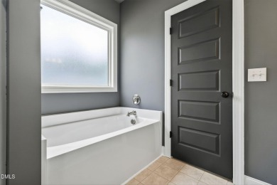 This better than new custom built 2021 home offers an open floor on River Golf and Country Club at Lake Royale in North Carolina - for sale on GolfHomes.com, golf home, golf lot