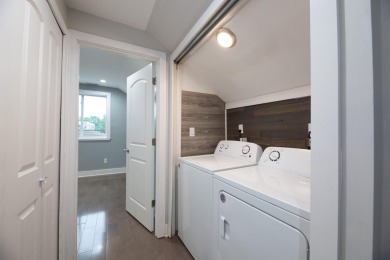 This cottage style bungalow surrounded by a white picket fence on Evergreen Hills Golf Course in Michigan - for sale on GolfHomes.com, golf home, golf lot