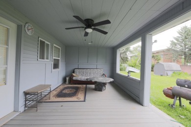 This cottage style bungalow surrounded by a white picket fence on Evergreen Hills Golf Course in Michigan - for sale on GolfHomes.com, golf home, golf lot