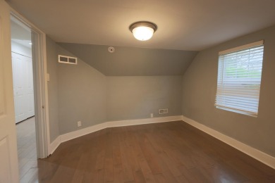 This cottage style bungalow surrounded by a white picket fence on Evergreen Hills Golf Course in Michigan - for sale on GolfHomes.com, golf home, golf lot